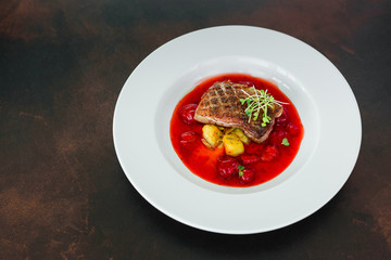 Steak  from fillet of a duck with caramelized strawberry and an eggplant