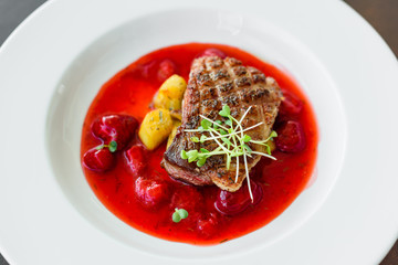 Steak  from fillet of a duck with caramelized strawberry and an eggplant