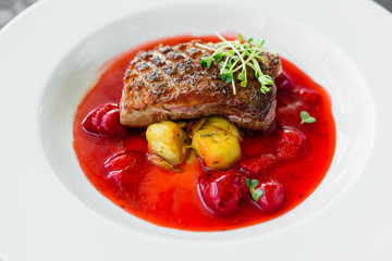 Steak  from fillet of a duck with caramelized strawberry and an eggplant