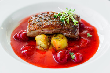 Steak  from fillet of a duck with caramelized strawberry and an eggplant