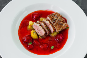 Steak  from fillet of a duck with caramelized strawberry and an eggplant