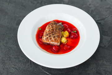 Steak  from fillet of a duck with caramelized strawberry and an eggplant