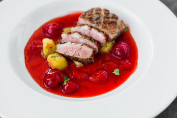 Steak  from fillet of a duck with caramelized strawberry and an eggplant