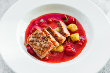 Steak  from fillet of a duck with caramelized strawberry and an eggplant