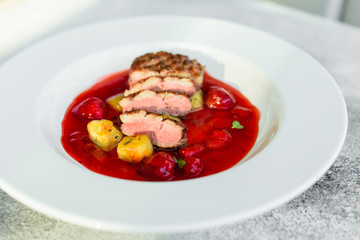 Steak  from fillet of a duck with caramelized strawberry and an eggplant