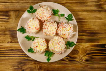Appetizer of crab-cheese balls on wooden table. Top view