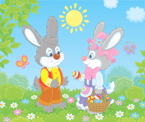 Little Easter Bunnies exchanging colored eggs on a green lawn among flowers and flittering butterflies on a sunny spring day, vector illustration in a cartoon style