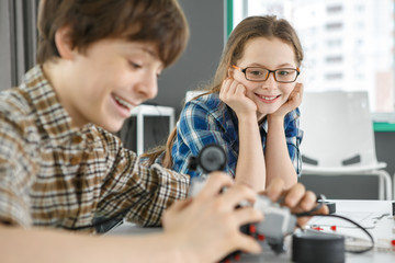 Brother and sister building a robot together at robotics school