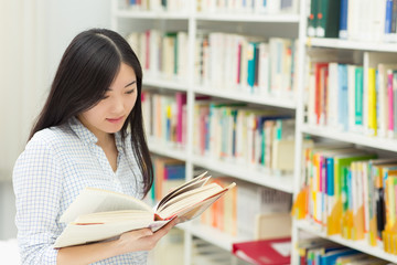 Young Asian female student at the library