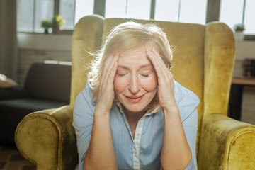 Short-haired blonde woman having problems and being in tragic state