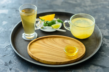 Tea with sea buckthorn in glass and honey. It can be used as a background