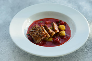 Steak  from fillet of a duck with caramelized strawberry and an eggplant