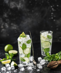 Mojito cocktail with lime and mint in highball glass on a dark stone background. Fresh summer cocktail