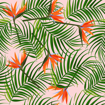 Bright tropical background. Palm leaves and bird of paradise strelitzia seamless pattern.