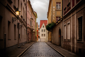 Dark, cobblestone covered street in the historic old town of Augsburg, a romantic medieval city in...