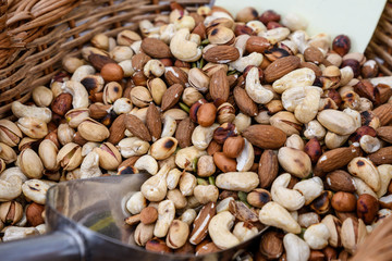 Close up of mixed nuts available for sale at a food market, fried salted pistachio, cashew, almonds and peanuts