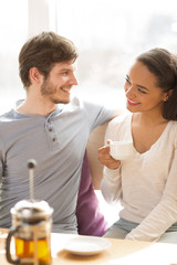 Young beautiful couple having a date at the cafe