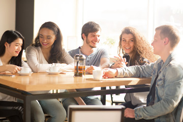 Happy friends hanging out at the cafe together