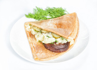 Thin delicious pancake with meat steak and mashed potatoes on white