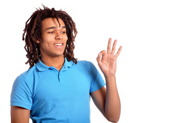 Young man showing ok against white background