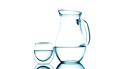 Jug and glass of water on white background
