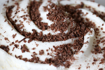 Ice cream sprinkled with grated chocolate. Tasty creamy dessert close up