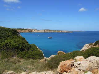 picture of the coast of the beautiful Menorca island in Spain. the mix of the green and blue colours of water and land create a beautiful natural effect. 