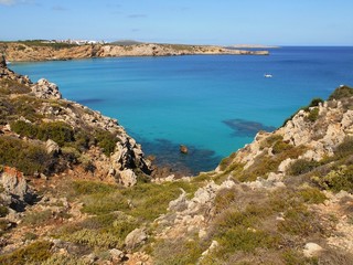 picture of the coast of the beautiful Menorca island in Spain. the mix of the green and blue colours of water and land create a beautiful natural effect. 