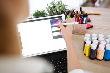 Young designer woman hand working with her digital tablet at the office.