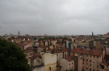 rooftops and view of the city on a rainy day, sunset in Lyon France