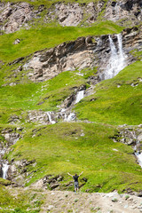 A young man at the alpine waterfall