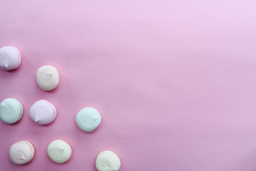 marshmallow in pastel colors on pink background with copy space.