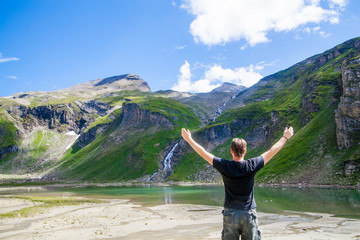 A young man at the alpine lake