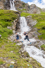 Fototapeta na wymiar A father and son at the alpine waterfall