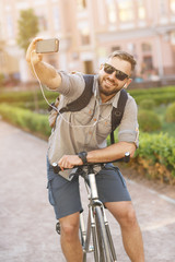 Naklejka premium Young handsome bearded man using his smart phone
