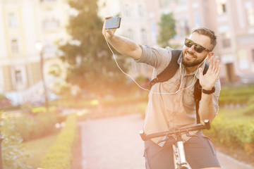 Young handsome bearded man using his smart phone