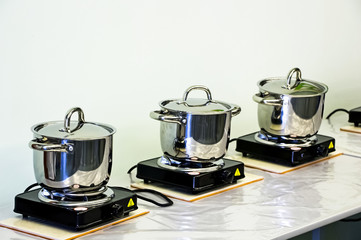 Steel pots on electric stoves. Cooking