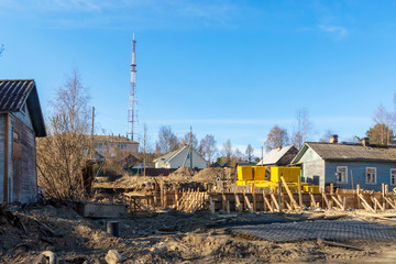 Construction site of low-rise house in downtown in spring