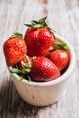 Fresh ripe strawberry on the dark rustic background. Selective focus. Shallow depth of field.