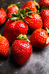 Fresh ripe strawberry on the dark rustic background. Selective focus. Shallow depth of field.