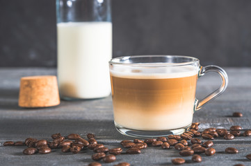 Spiced latte or coffee in a glass on a blue background