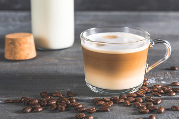 Spiced latte or coffee in a glass on a blue background