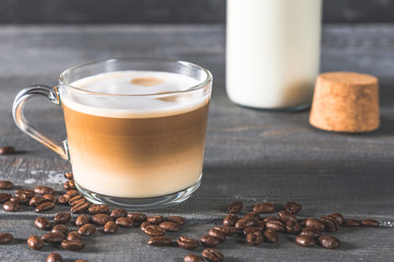 Spiced latte or coffee in a glass on a blue background