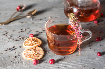 Tea cup with tea pot on wooden table