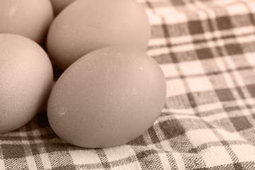 Fresh organic farm eggs on the table. Close-up. Image in sepia tones.