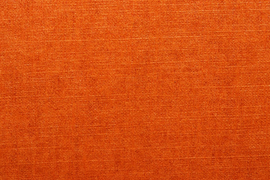 Orange texture. Closeup of a bright seamless orange paper or carton detail texture background for design and text. Macro.