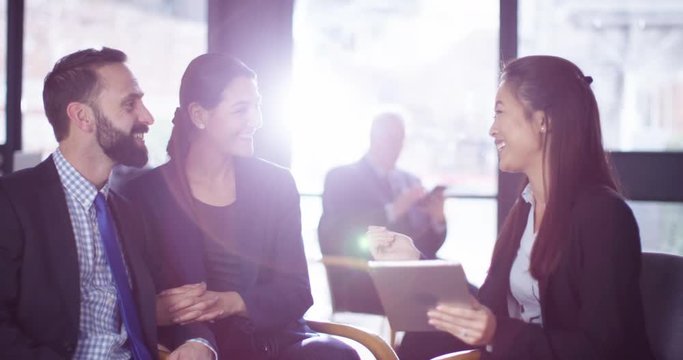 4K Female financial adviser in a meeting with smartly dressed young couple. Slow motion.