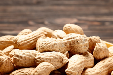 Рeanuts close up on wooden background. Place for text. Top view.