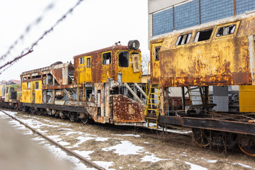 Rusty old weathered train standing outdoors. Horizontal color photography.