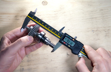 male hands with digital caliper